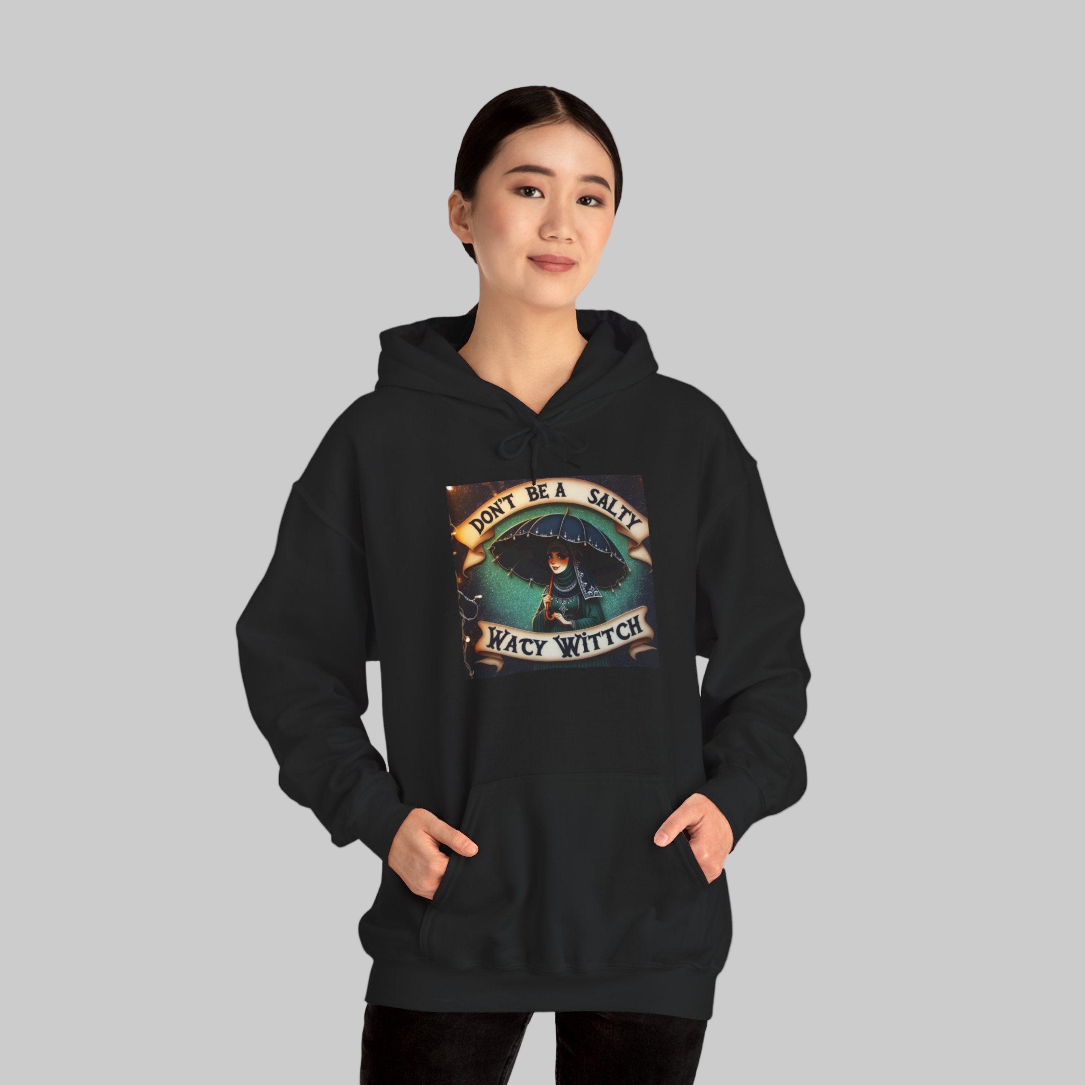 Witch a black hoodie with a graphic design 